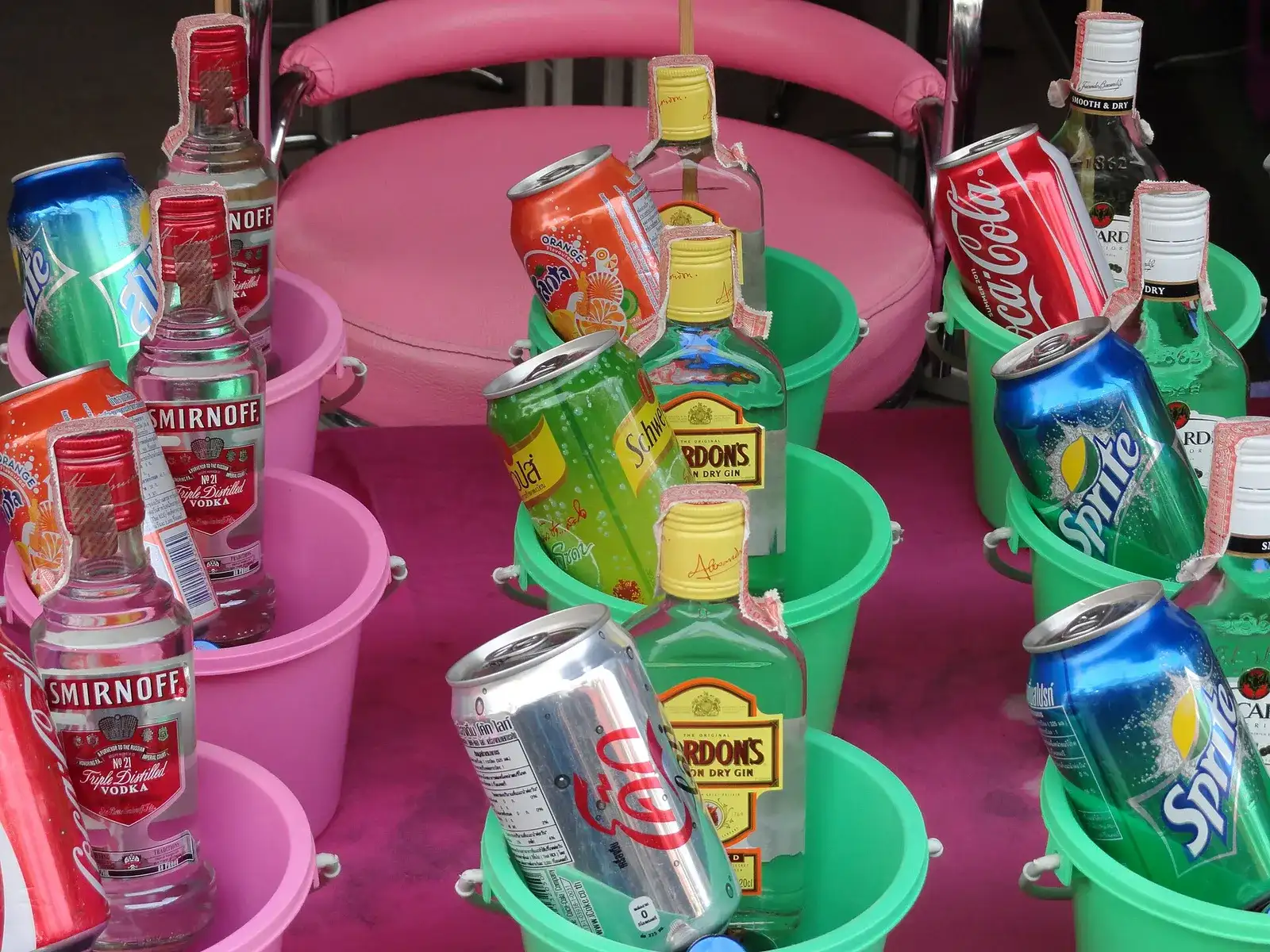 Party buckets with spirits and mixers lined up for sale in Haad Rin